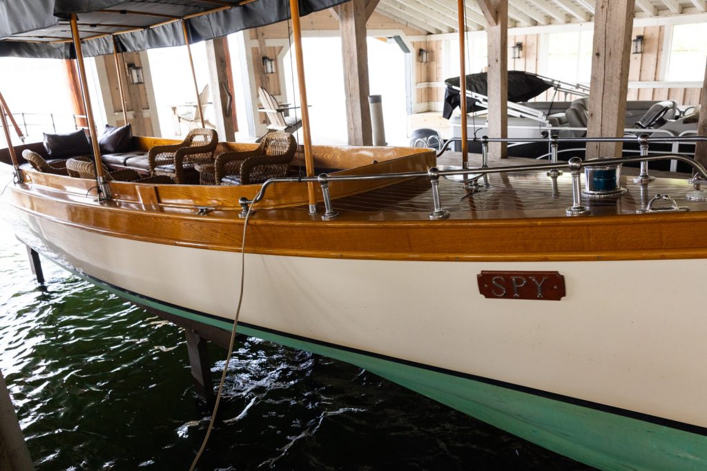 Vintage boat docked at Stout’s Island Lodge boat house, Wisconsin wedding venue.