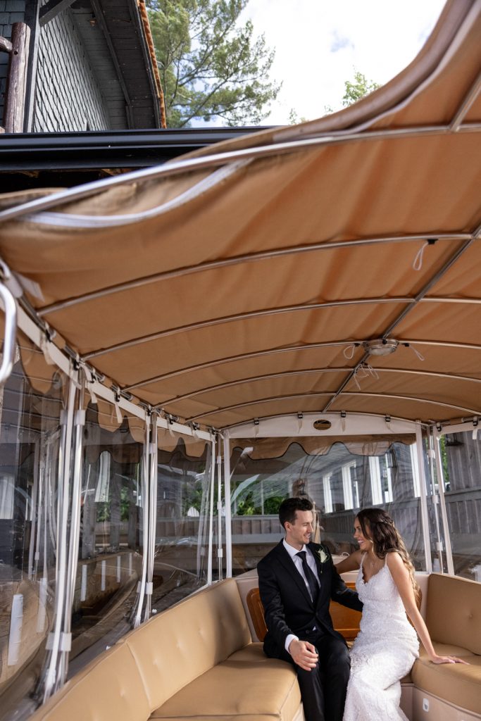 Bride and groom on boat transfer at Stout’s Island wedding in Birchwood, Wisconsin.