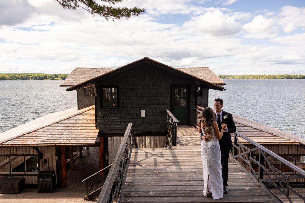 Brittany and Cole on Stout’s Island boat house, Red Cedar Lake wedding photography.