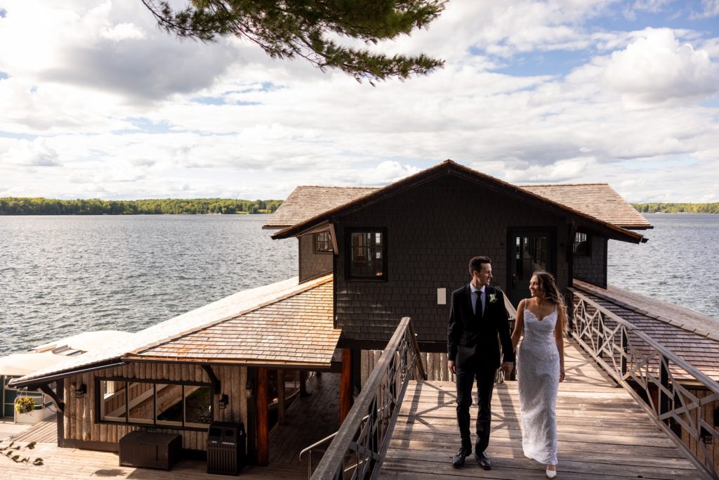 Brittany and Cole walking on Stout’s Island dock, Wisconsin wedding photography and videography.