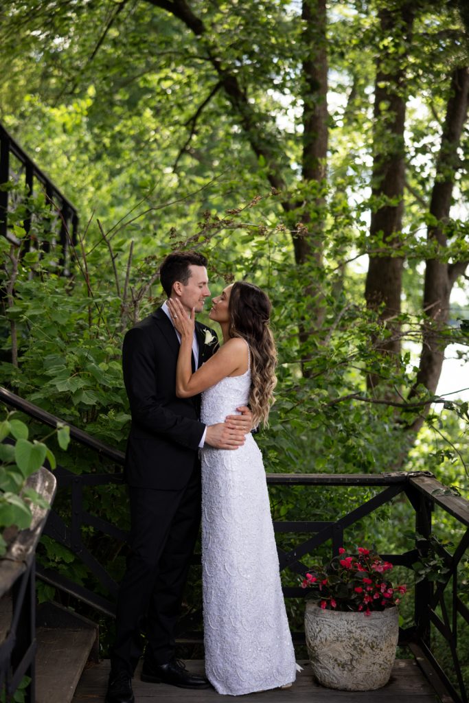 Brittany and Cole embracing on Stout’s Island stairs, Wisconsin wedding photography.