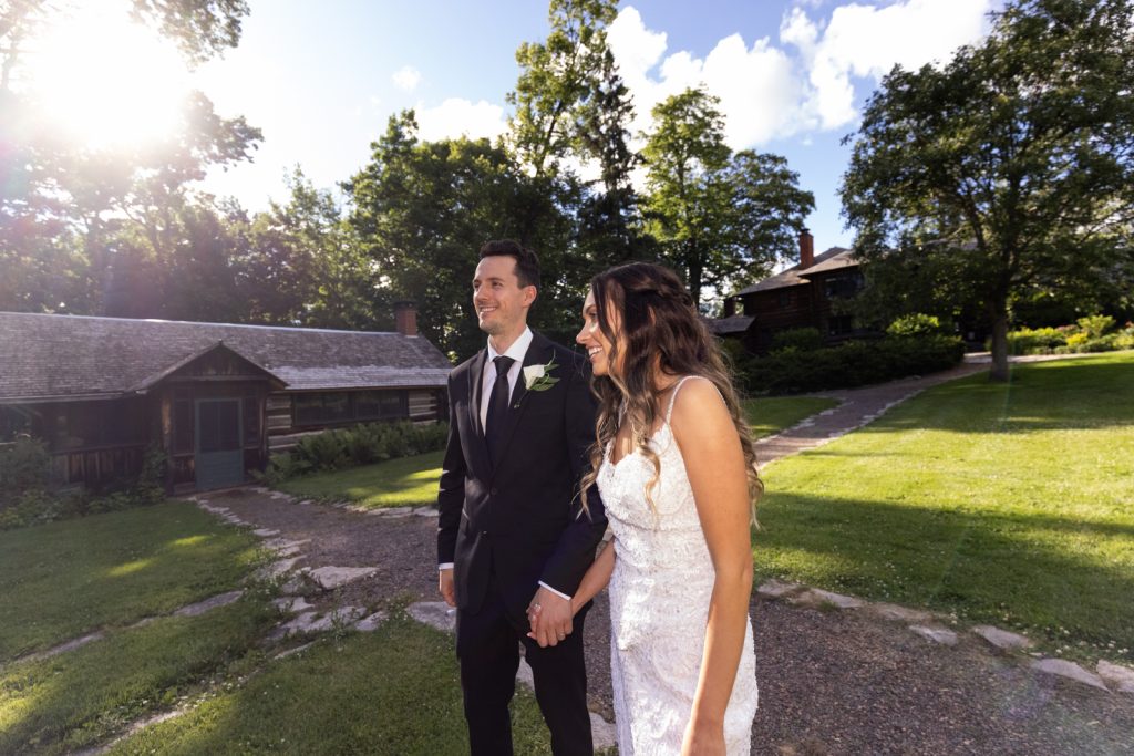 Brittany and Cole, the wedding couple, walking hand-in-hand on Stout’s Island in Wisconsin.