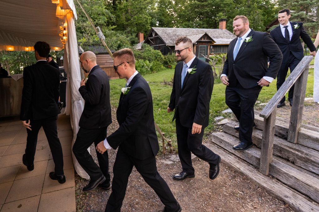 Brittany and Cole’s Stout’s Island wedding party descending wooden stairs, Wisconsin wedding photography.