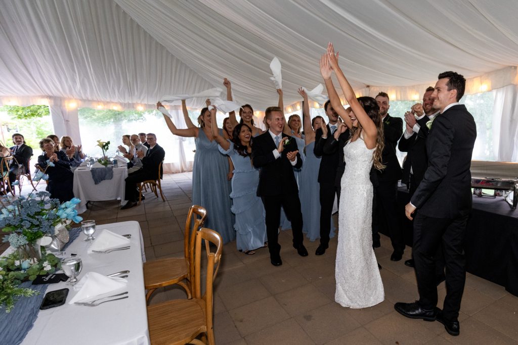 Brittany and Cole wedding celebration at Stout’s Island Lodge, Birchwood, Wisconsin, with guests throwing confetti.