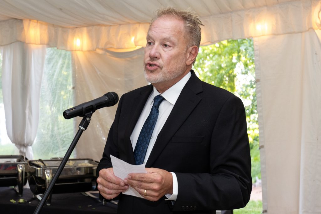 Man speaking into microphone at Stout’s Island wedding reception in Birchwood, Wisconsin