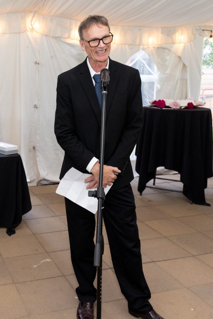 Man speaking into microphone at Stout’s Island wedding reception in Birchwood, Wisconsin.