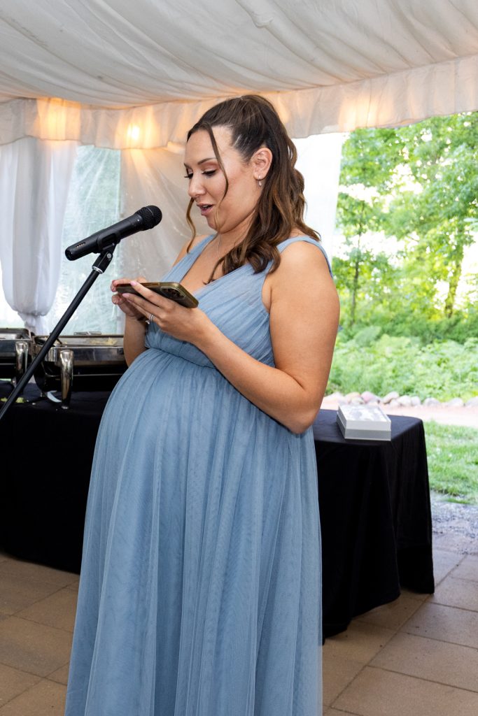 Bride Brittany reading a speech at Stout’s Island wedding reception in Birchwood, Wisconsin.