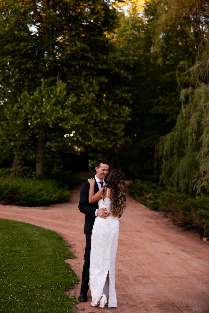 Brittany and Cole embracing on a path at Stout’s Island wedding in Birchwood, Wisconsin.
