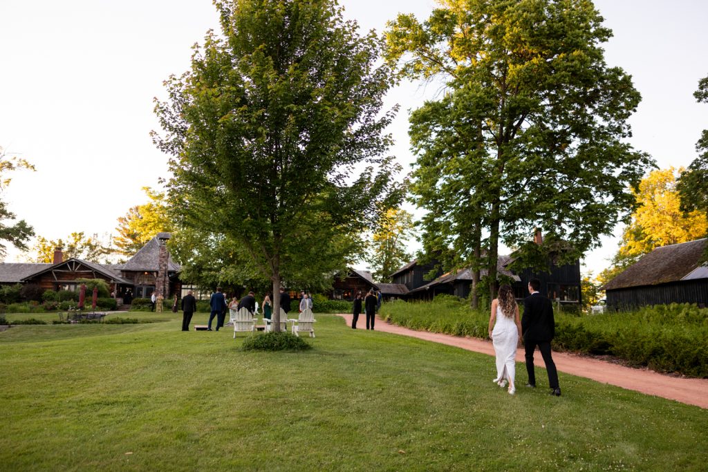 Brittany and Cole walking on Stout’s Island grounds, Wisconsin wedding photography and videography.