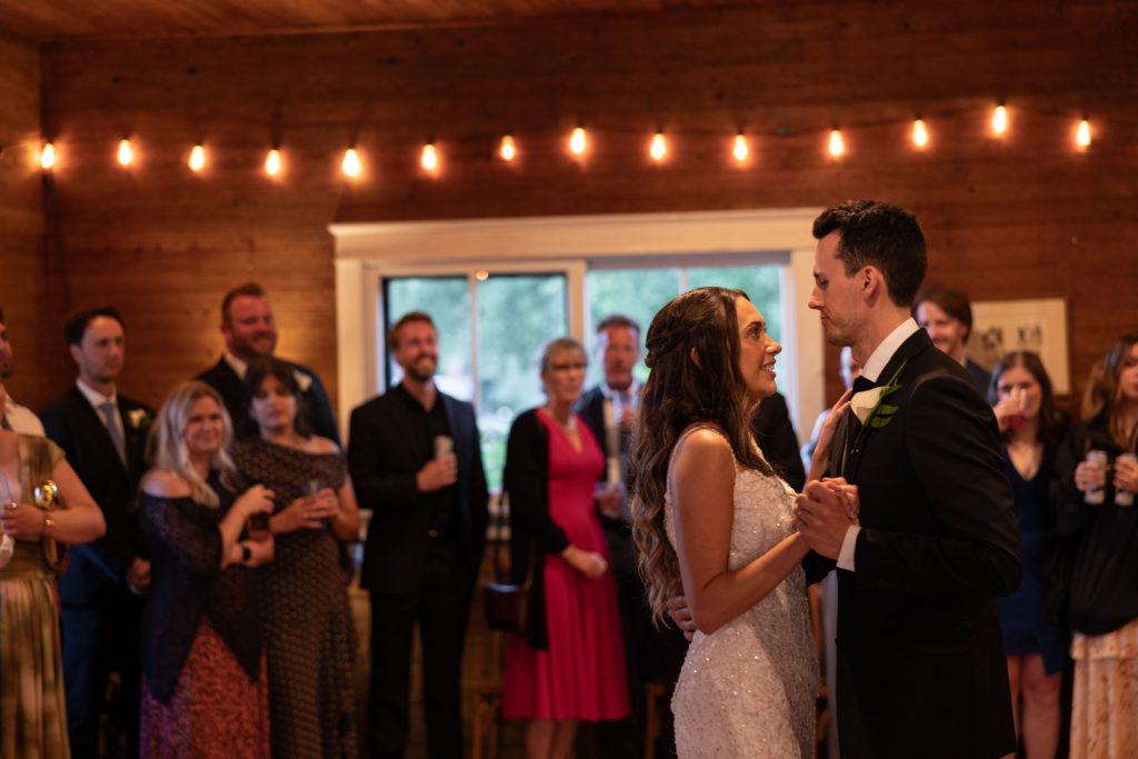 Brittany and Cole dancing at their Stout’s Island wedding reception, surrounded by guests and string