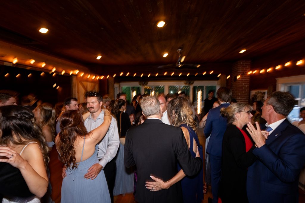 Brittany and Cole's wedding reception at Stout’s Island Lodge, Birchwood, Wisconsin, with guests dancing and