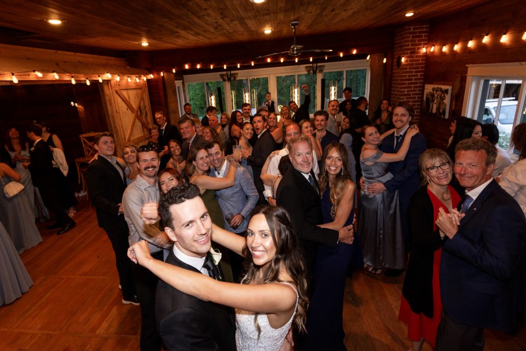 Brittany and Cole wedding reception group photo at Stout’s Island Lodge in Birchwood, Wisconsin.