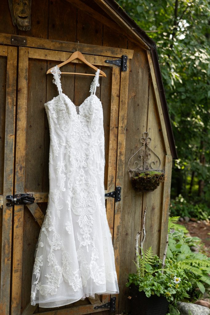 Bride's wedding dress hanging on cabin door at Hayward, WI wedding.