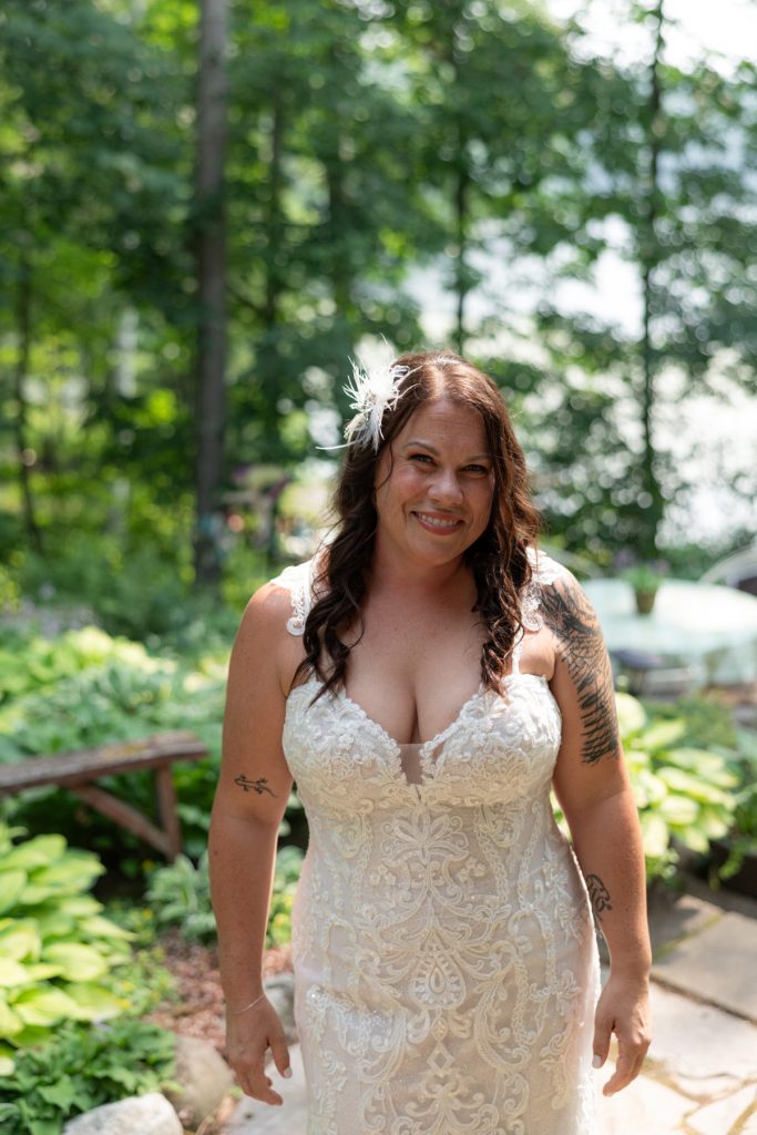 Bride in wedding dress smiling in lakeside backyard wedding in Hayward, WI