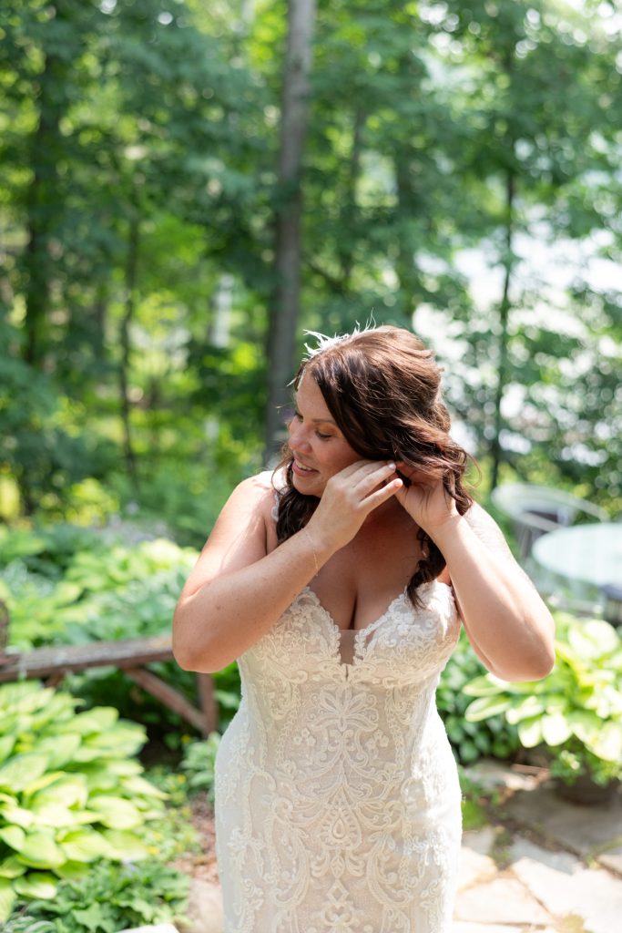 Bride getting ready in wedding dress at lake cabin in Hayward, WI