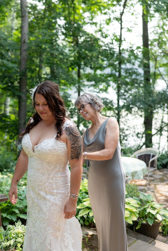 Bride getting ready with mother at lakeside cabin wedding in Hayward, WI