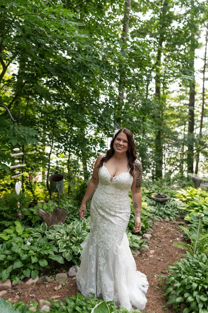 Bride in wedding dress smiling in lakeside backyard setting, Hayward, WI wedding photography.