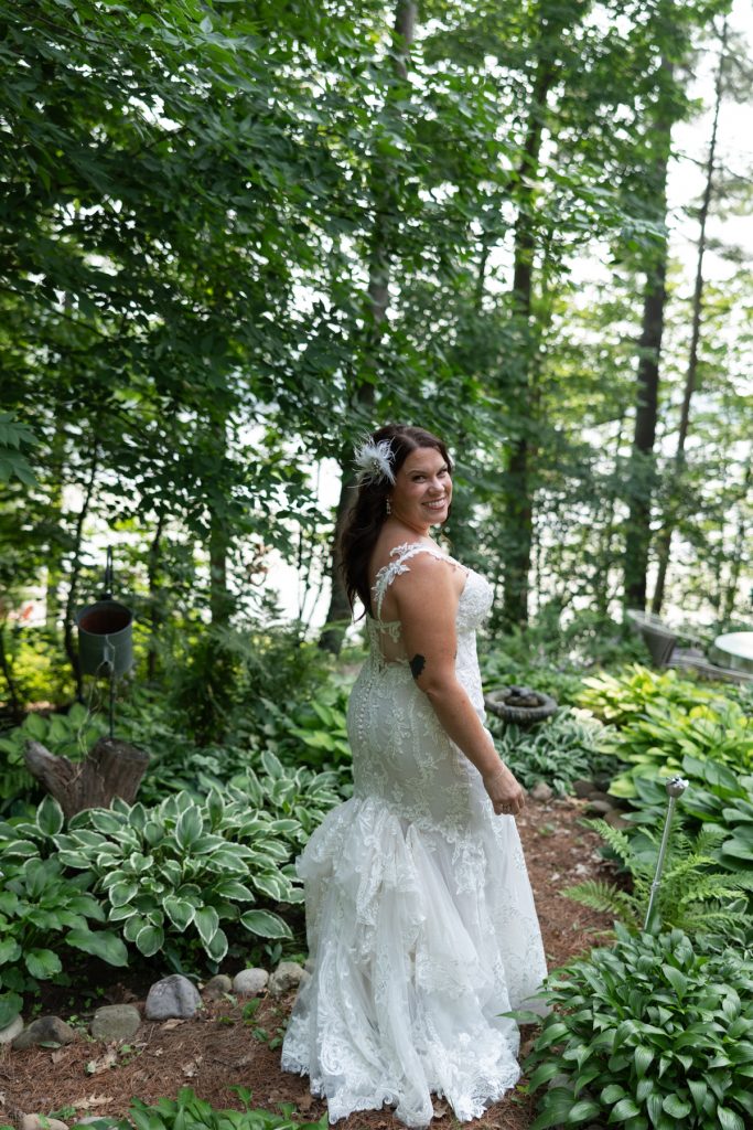 Bride in wedding dress overlooking lake at Hayward, WI cabin wedding