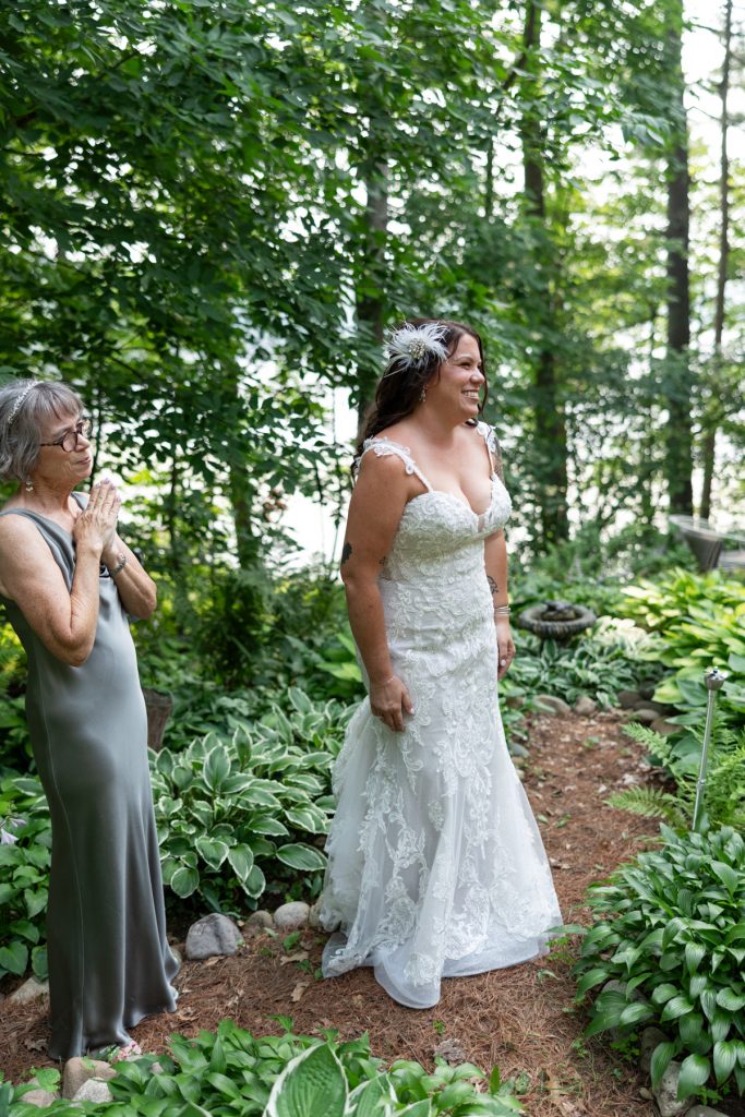 Bride in wedding dress with mother, Hayward, WI lakeside cabin wedding.