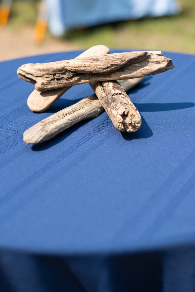 Driftwood decor on a blue table at a Hayward, WI lakeside wedding.