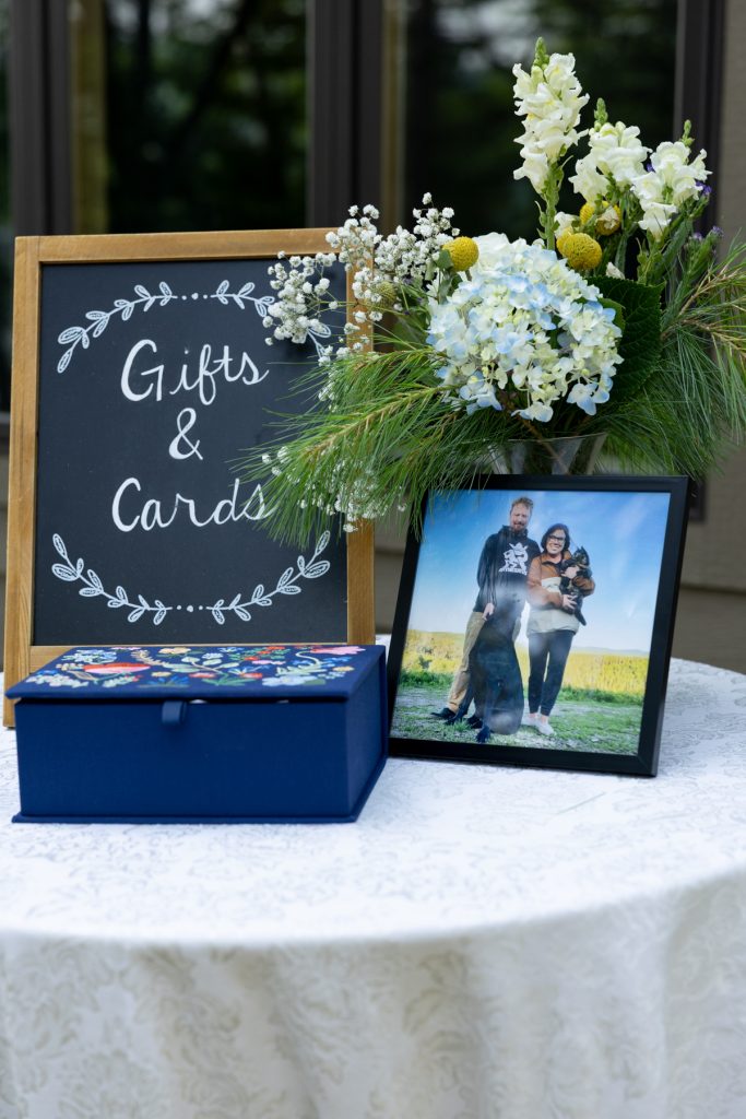 Wedding gifts and cards display with framed photo of couple and dog at Hayward, WI