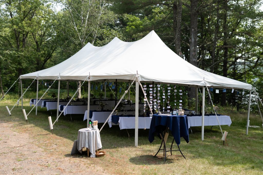 Wedding reception tent overlooking lake in Hayward, WI, backyard wedding details