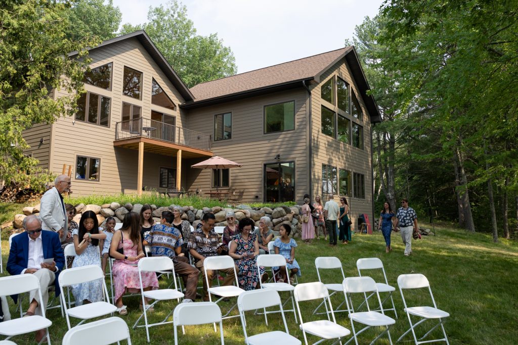 Lakefront cabin wedding ceremony in Hayward, Wisconsin, with guests seated and bride approaching