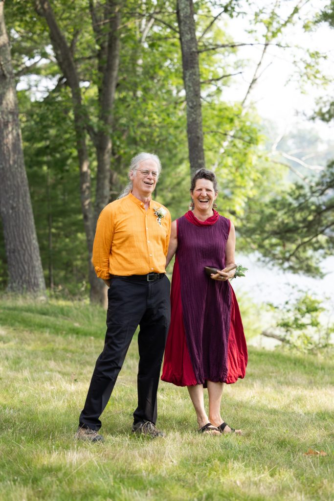 Couple smiling at a lake-side wedding in Hayward, WI