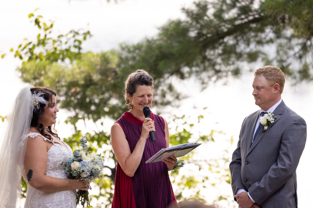 Bride and groom exchanging vows at lakeside wedding in Hayward, WI.
