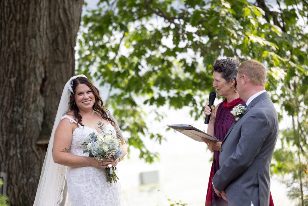 Bride and groom during lakeside wedding ceremony in Hayward, WI