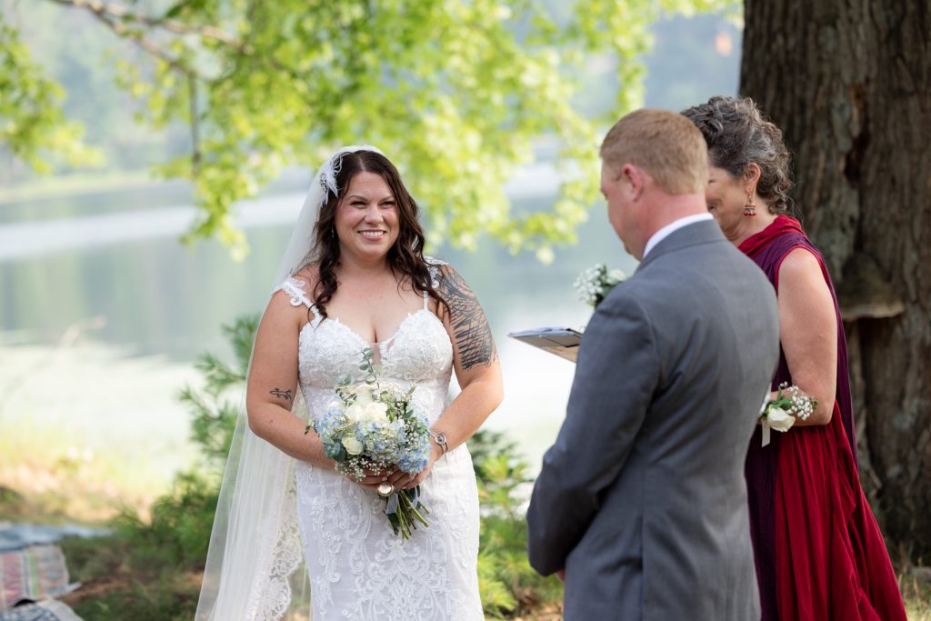 Bride and groom exchanging vows at lakeside wedding in Hayward, WI