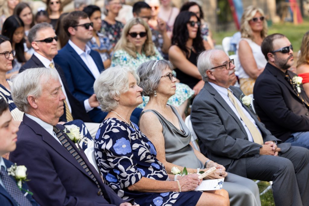 Wedding guests seated at lakeside ceremony in Hayward, Wisconsin.