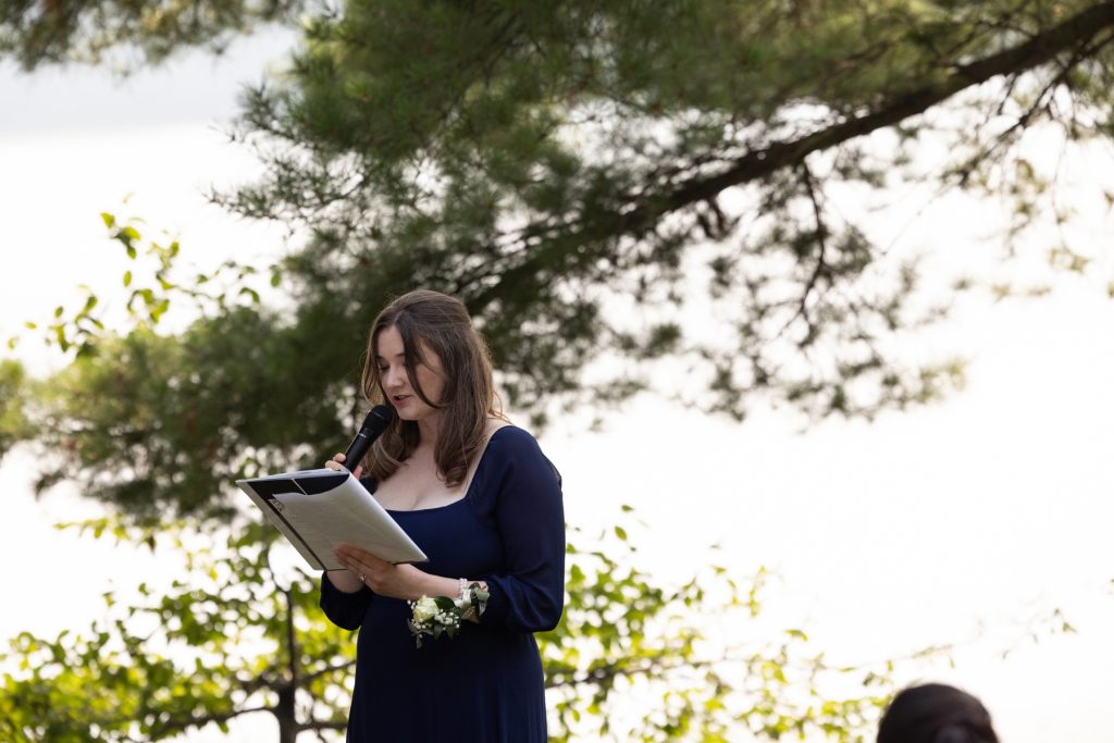 Bride reading vows at lakeside wedding in Hayward, WI.