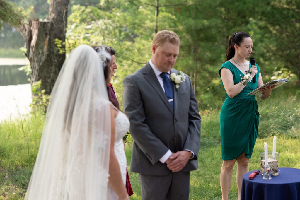 Bride and groom during lakeside wedding ceremony in Hayward, WI