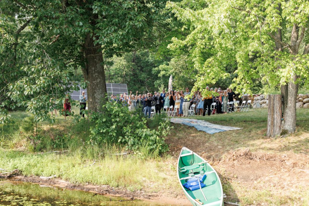 Wedding ceremony at family cabin on the lake in Hayward, Wisconsin, with guests and a
