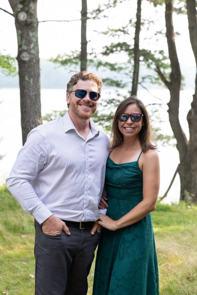Couple smiling and posing at lakeside wedding in Hayward, WI