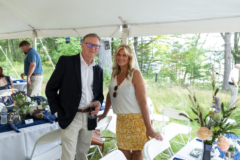 Couple smiling at a lakeside wedding reception in Hayward, WI