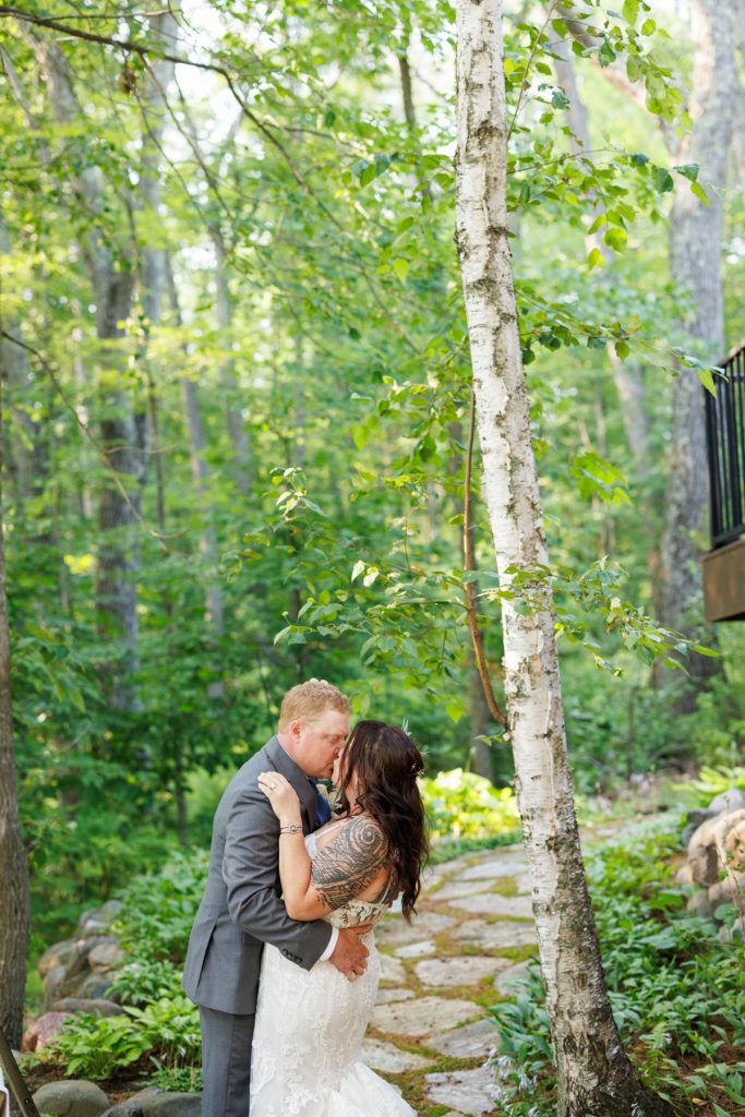 Bride and groom kissing in a lakeside cabin setting, Hayward, WI wedding photography.