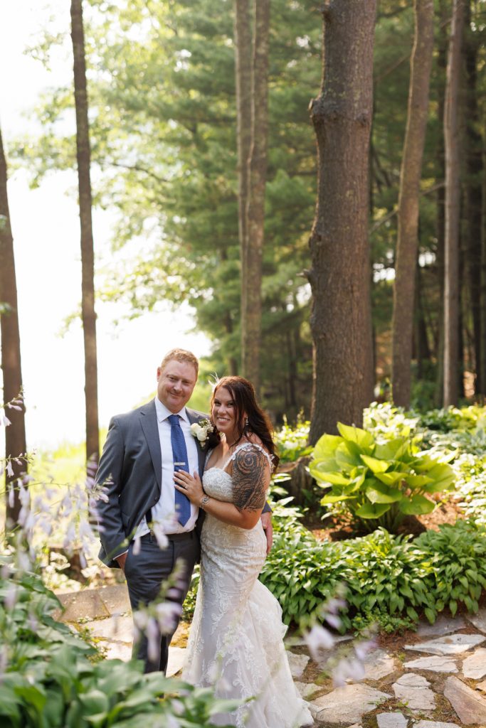 Bride and groom embracing in lakeside cabin wedding in Hayward, WI