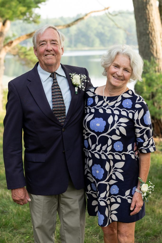 Bride and groom smiling together at a lake-side wedding in Hayward, WI.