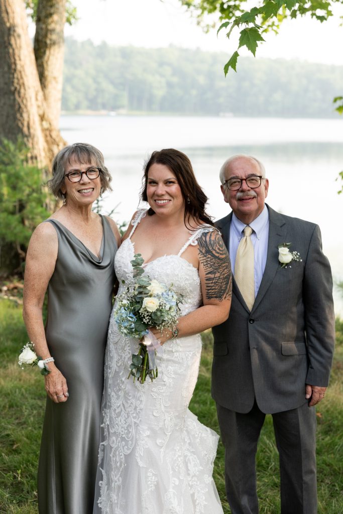 Bride with parents at lakeside wedding in Hayward, WI