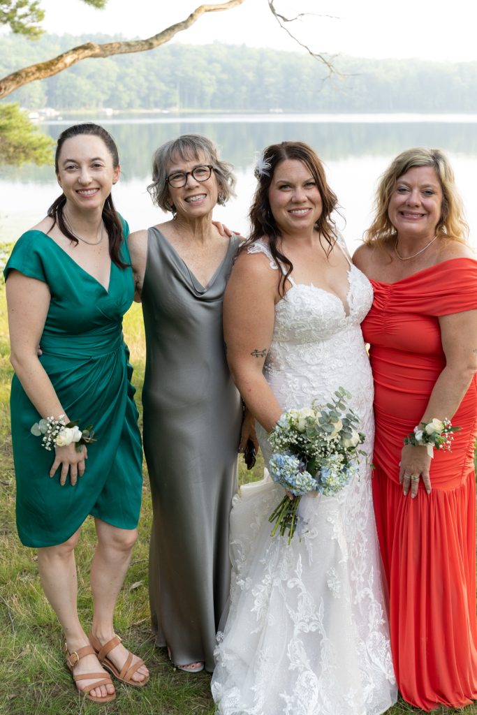 Bride and family posing at lake-side wedding in Hayward, WI.
