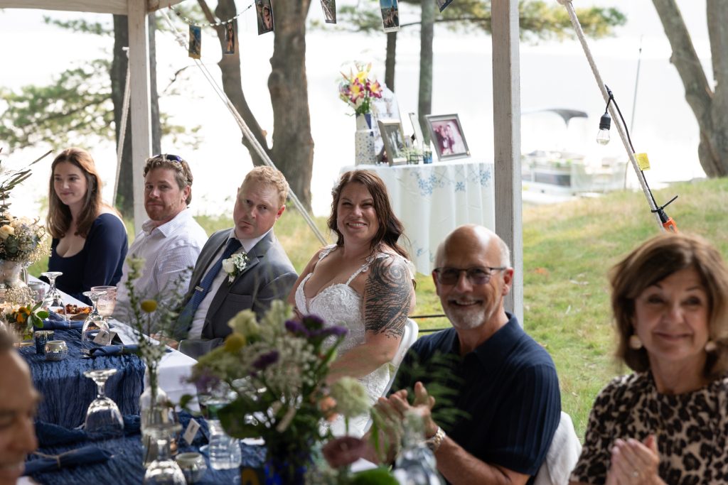Bride and guests at wedding reception overlooking lake in Hayward, WI