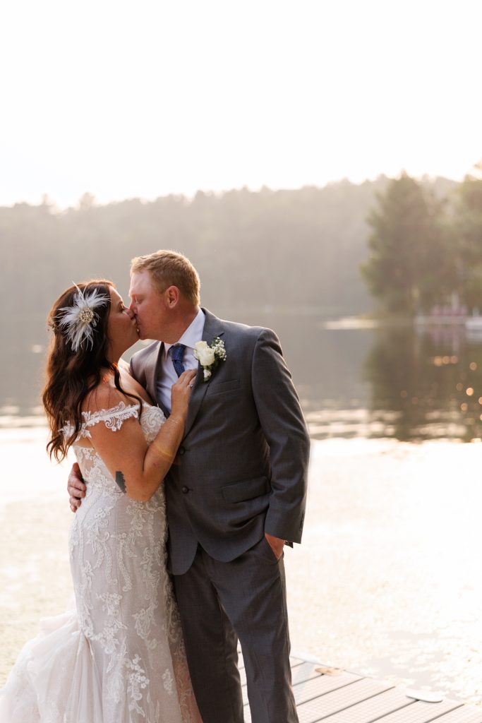 Bride and groom kissing on lake dock at Hayward, WI wedding