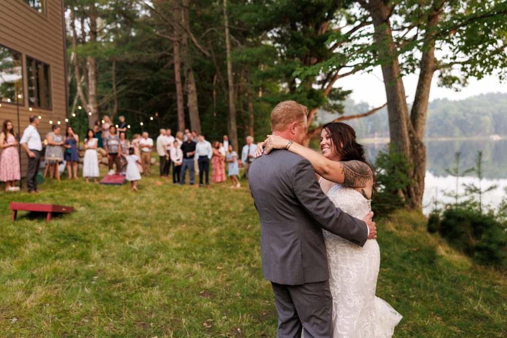 Bride and groom dancing at lakeside wedding in Hayward, WI