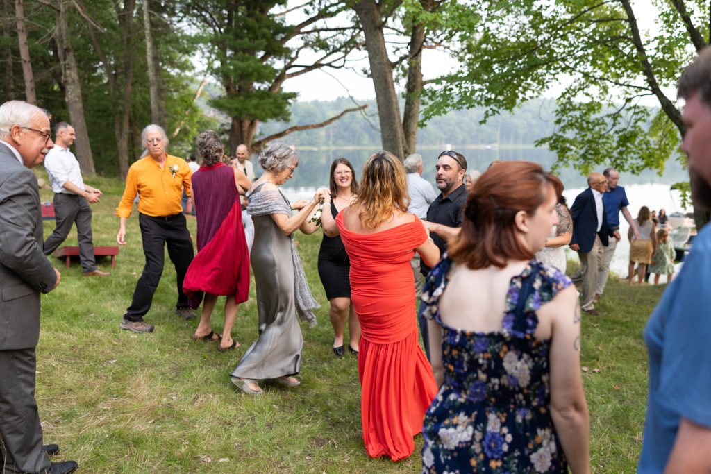 Bride and guests dancing at a lakeside wedding in Hayward, WI.
