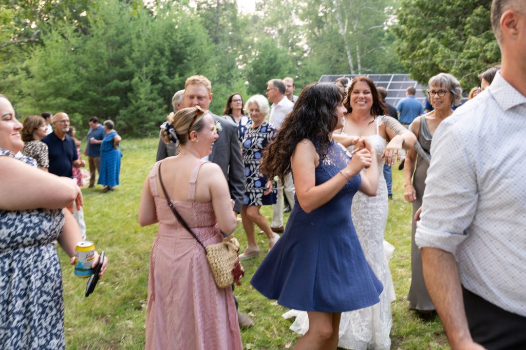 Wedding guests dancing at a lakeside cabin wedding in Hayward, WI