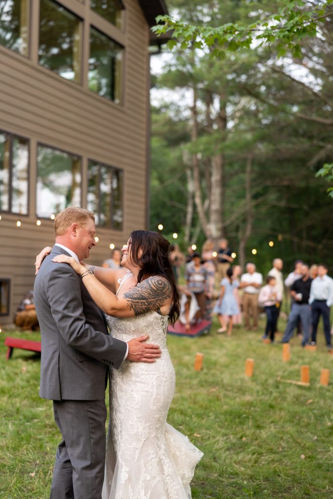 Bride and groom dancing at a lakeside cabin wedding in Hayward, WI.