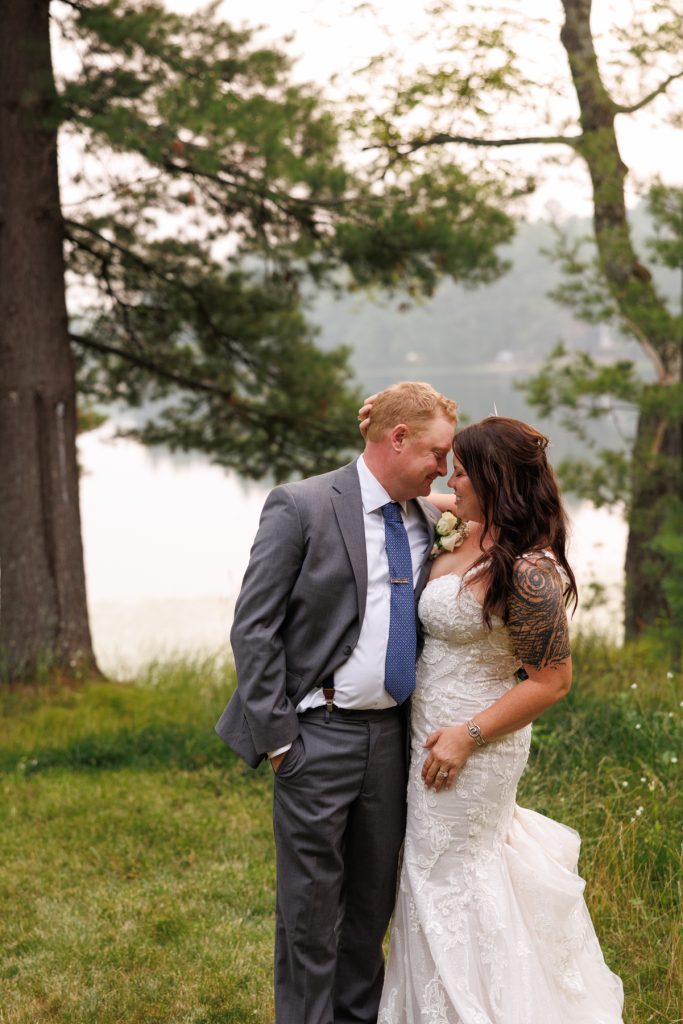 Bride and groom embracing at lake-side wedding in Hayward, WI