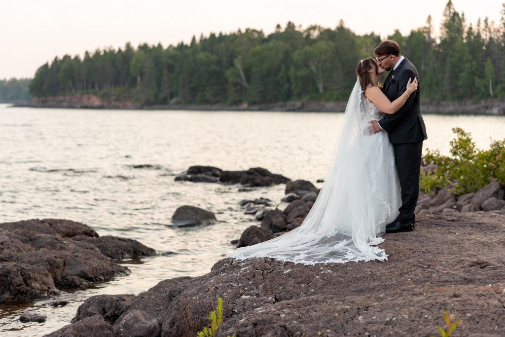 Bride and groom share a romantic kiss during their wedding ceremony on the Wisconsin North